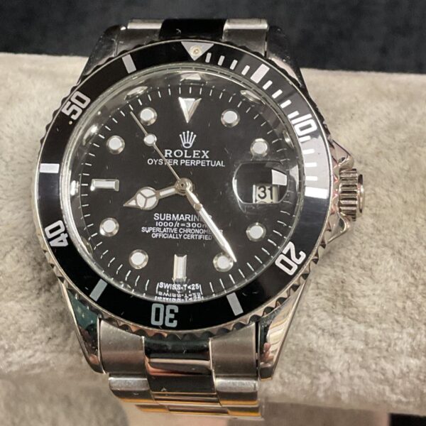 Close-up of replica Rolex Submariner watch with black bezel.