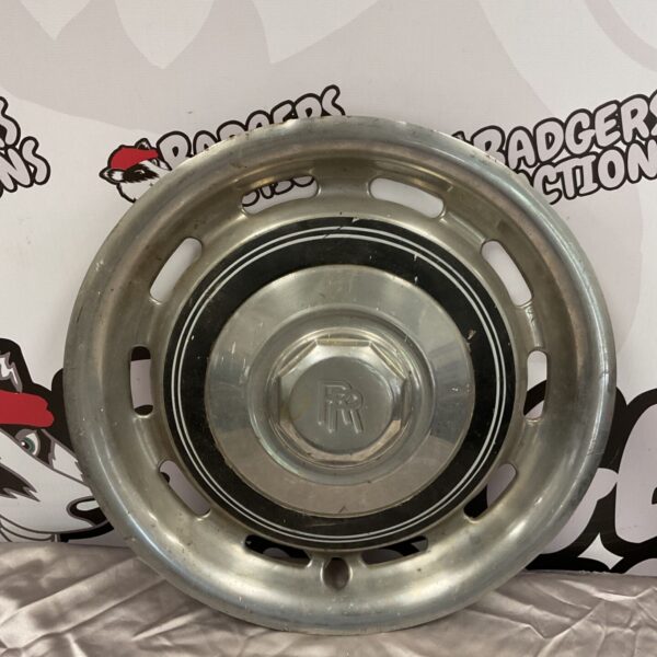 Vintage Rolls Royce hub cap with central emblem.