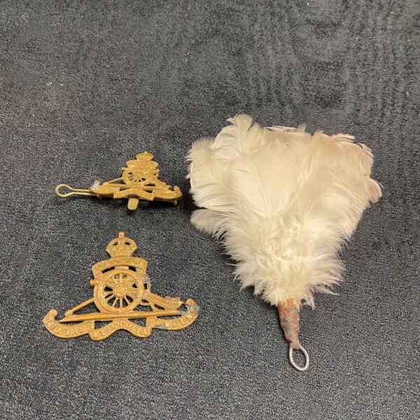 Royal Artillery cap badges and white feather hackle, British military collectibles.