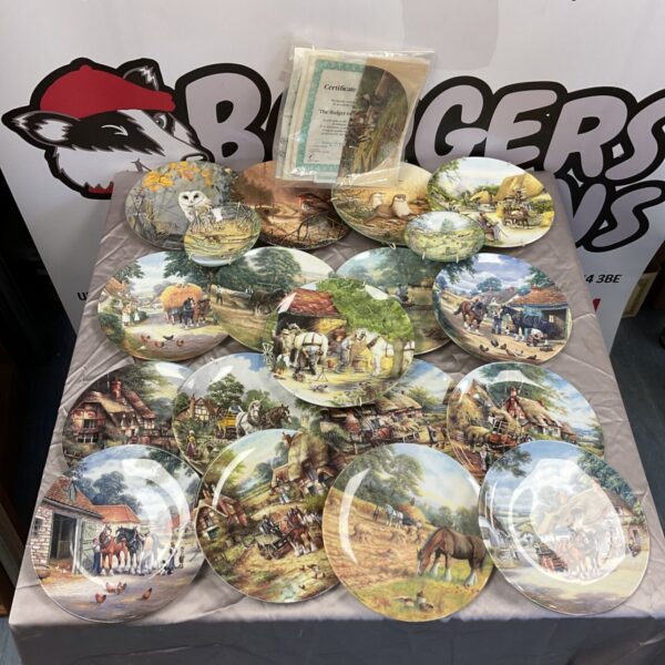 Royal Doulton and Wedgewood collectors plates displayed on a table.