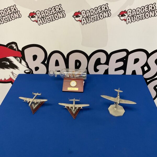 Royal Hampshire war plane models with ship in a bottle clock.