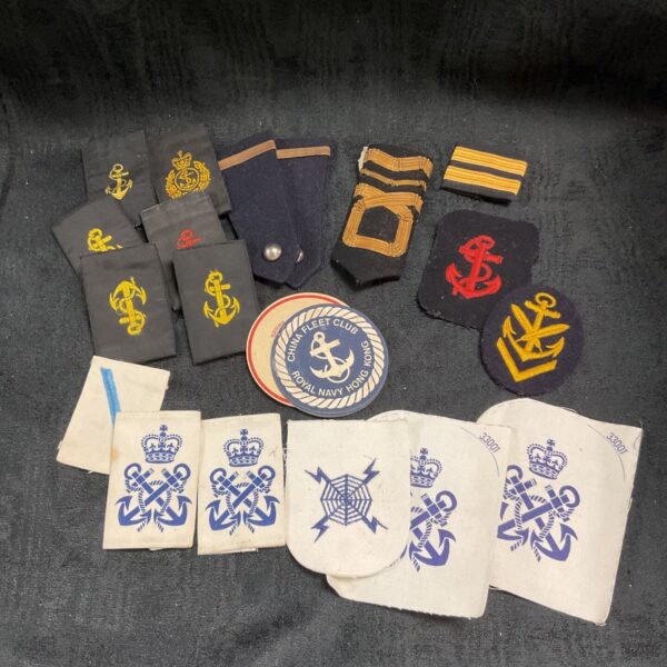 Collection of vintage Royal Navy rank boards and badges for collectors.