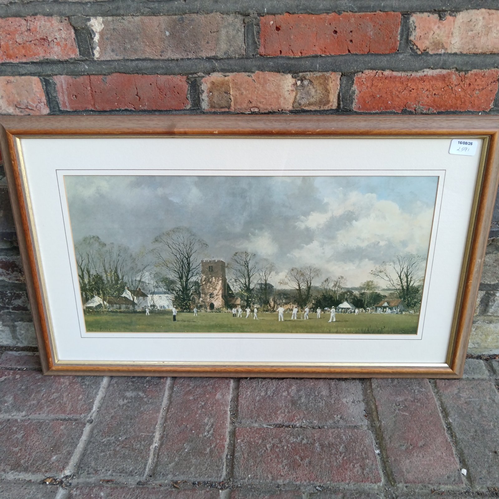 Framed Royal Perry print of a vintage cricket match and church.