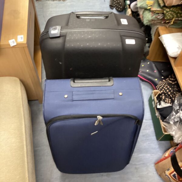 Samsonite and Tripp wheeled suitcases, travel luggage pair.