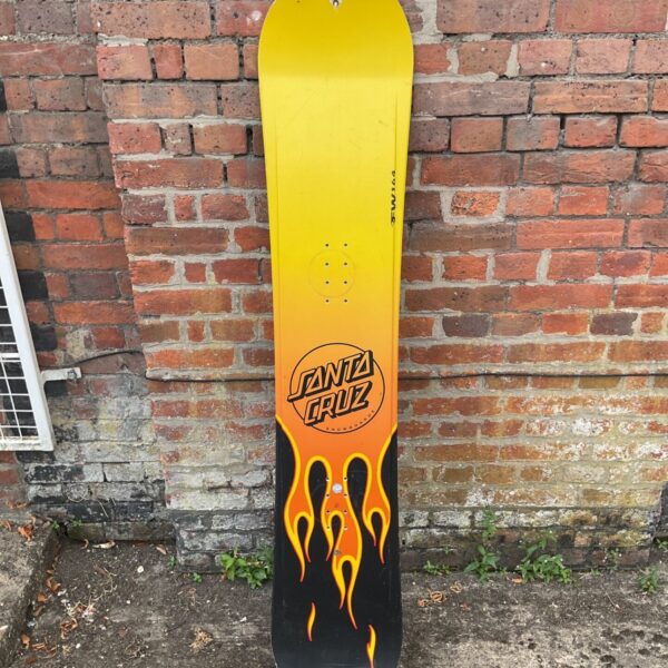 Vintage Santa Cruz snowboard with colourful graphics.