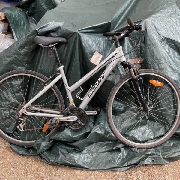 Silver Scott mountain bike with front suspension and durable tyres.