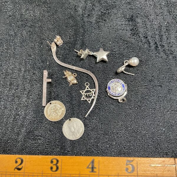 Vintage scrap silver jewellery lot including pendants and a brooch.