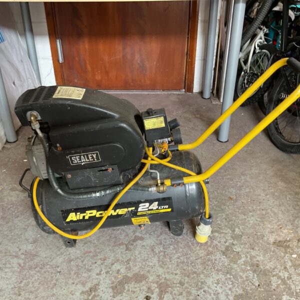 Portable Sealey AirPower 24L air compressor with yellow hose.