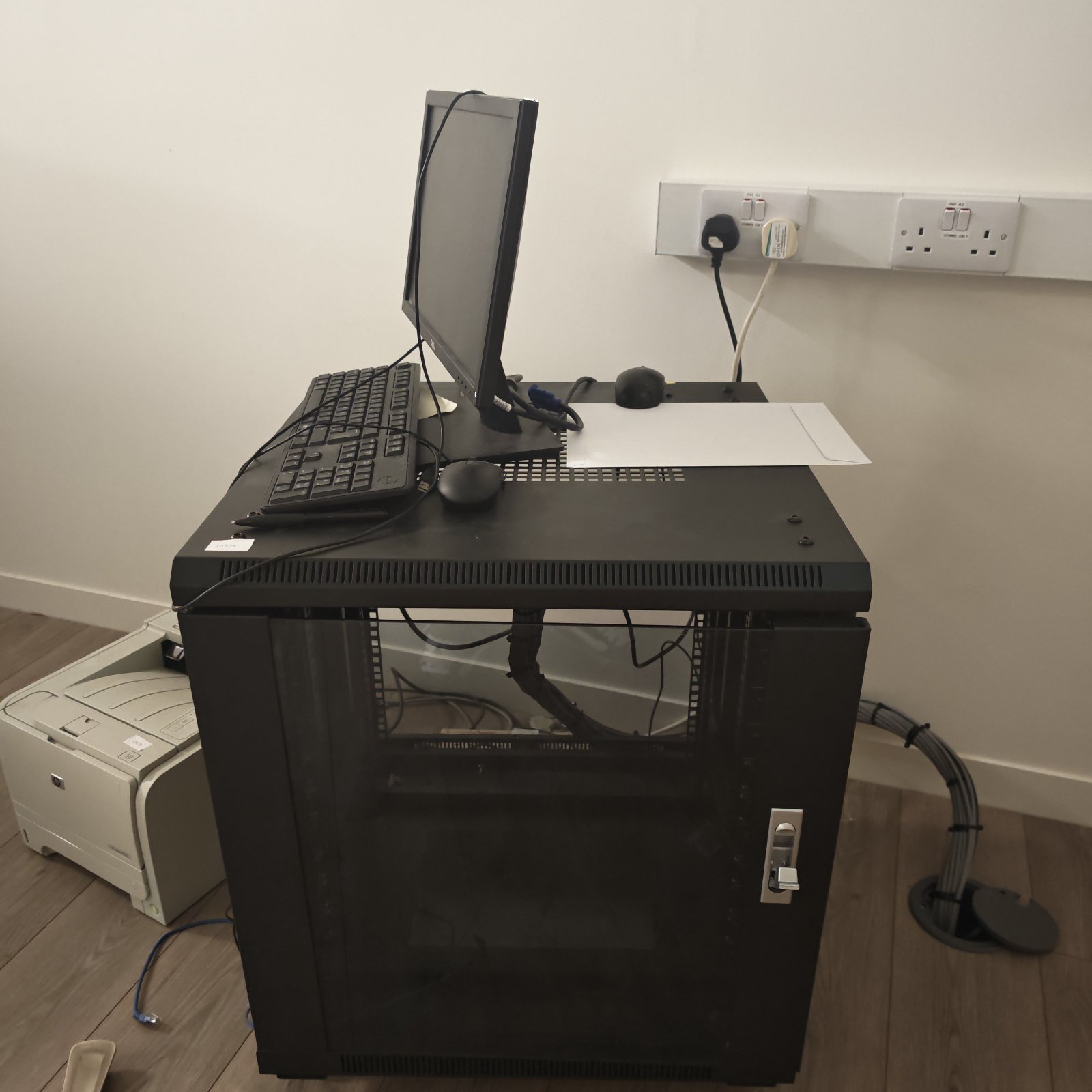 Server cabinet with Dell monitor and keyboard for network equipment.