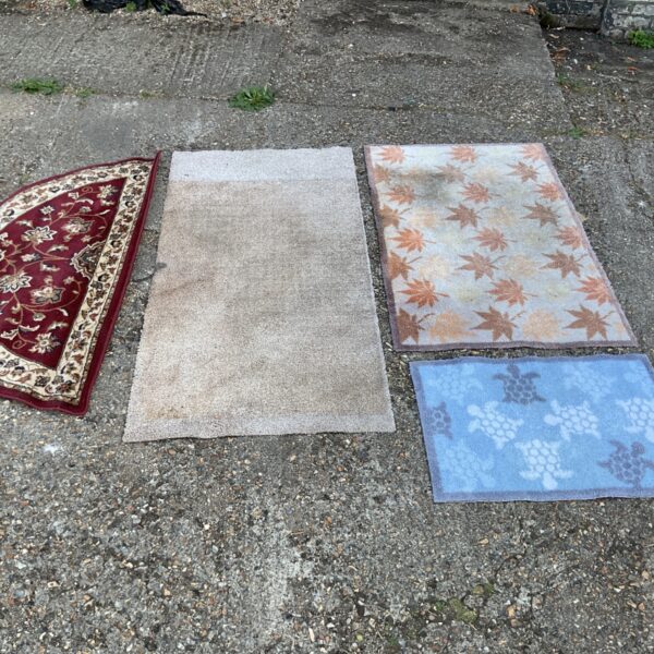 Red Sherborne Sincerity rug with non slip mats displayed.