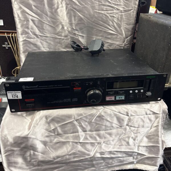 Black vintage Sherwood professional compact disc player with controls.