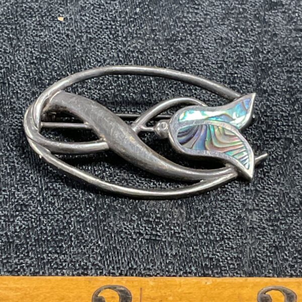 Silver Art Nouveau brooch with iridescent enamel flower detail.