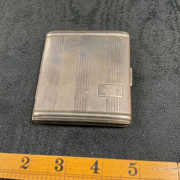 Vintage silver compact with Golly character engraving.