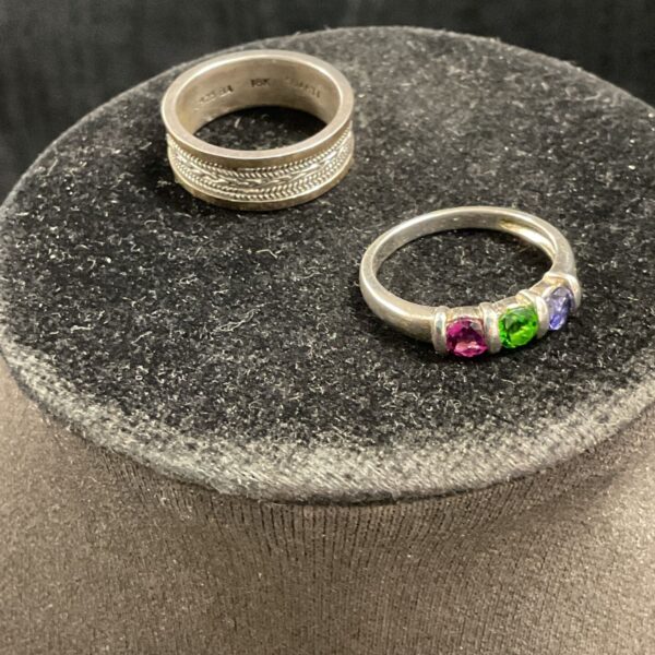 Silver ring with red, white, and blue cubic zirconia stones.