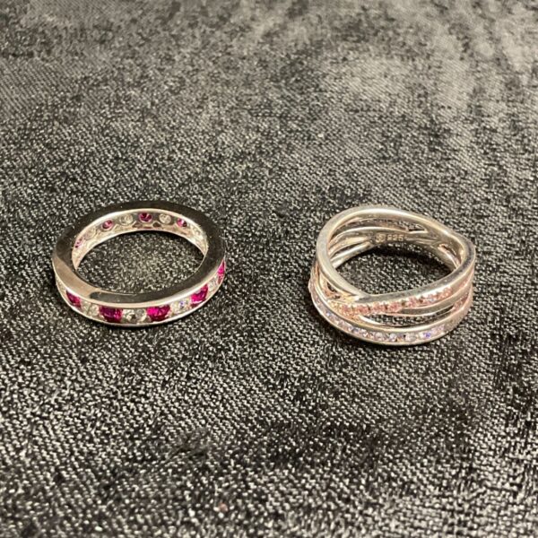 Silver CZ ring set featuring red, white, and pink stones, size M.