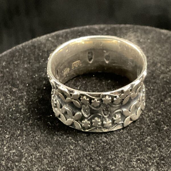 Close-up of a vintage silver floral ring, size R.
