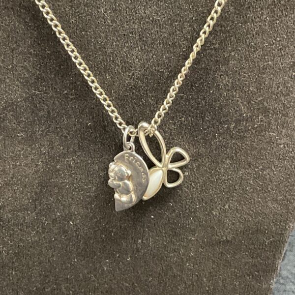 Delicate silver necklace with Friends and flower pendants.