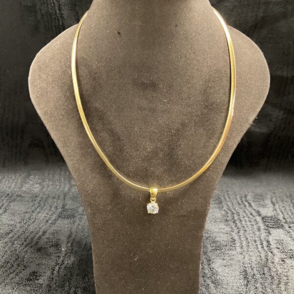 Silver gilt choker necklace with large white stone pendant.