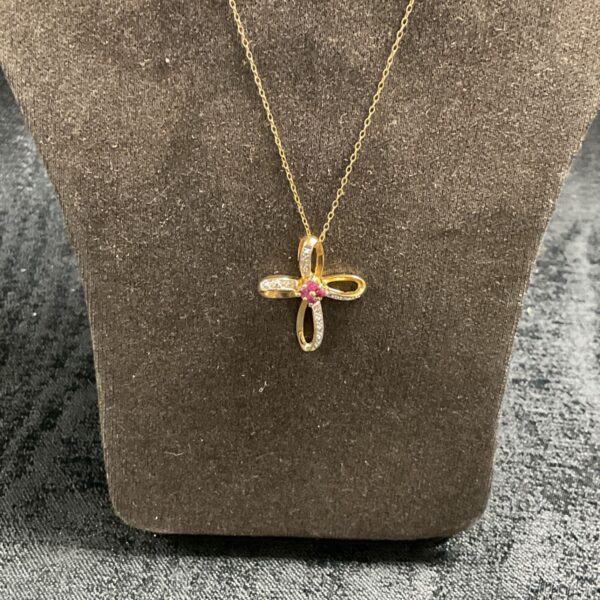 Silver gilt cross pendant with red stones and 18 inch necklace.
