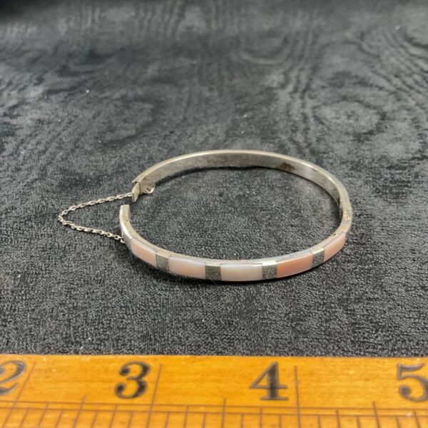 Silver hinged bracelet with mother of pearl inlay.