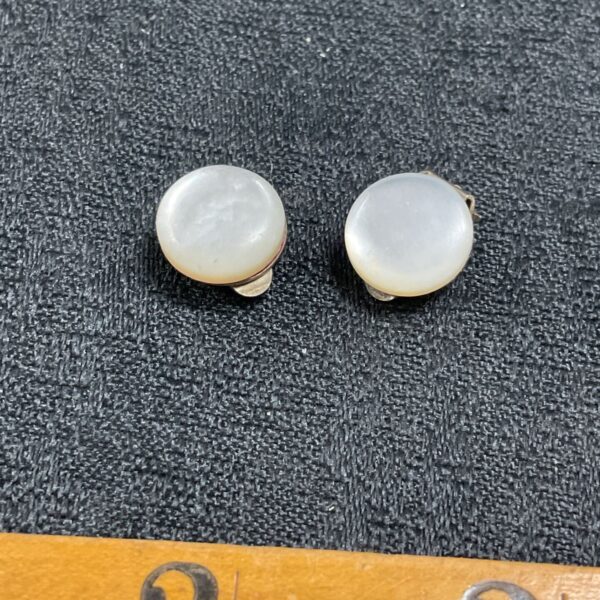 Close-up of vintage silver mother of pearl clip-on earrings.