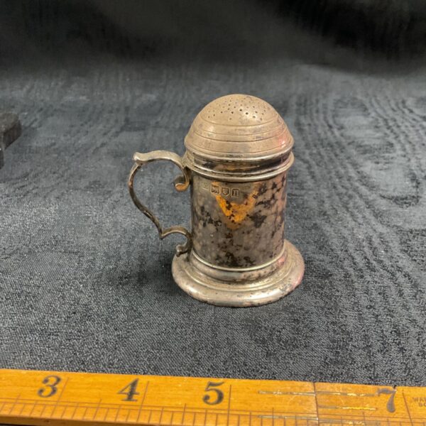 Antique silver pepper shaker with hallmarked silver and pierced top.