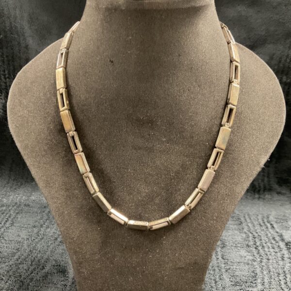 Close-up of a vintage 925 silver rectangular link necklace.