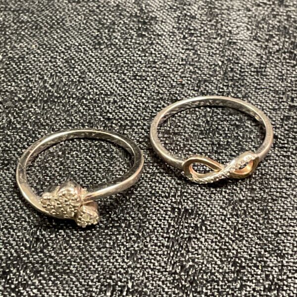 Silver ring pair, size M, with floral and rose gold designs.
