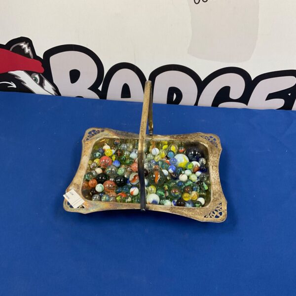 Vintage silver plated tray filled with colourful glass marbles.