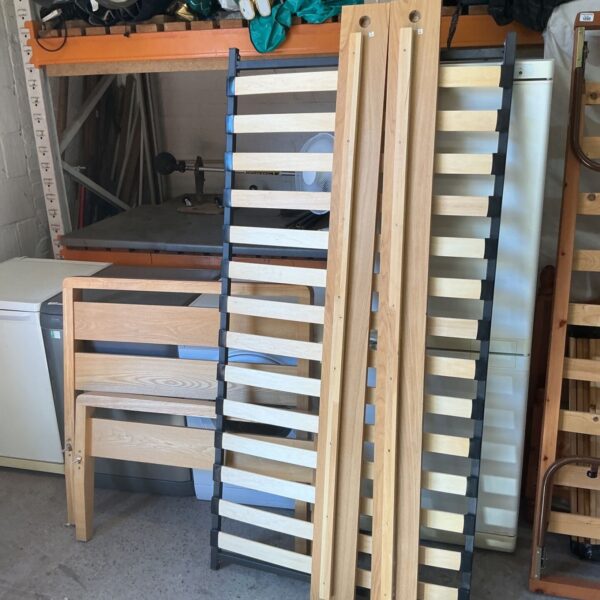 Vintage single wooden bed frame with slats, ready for restoration.