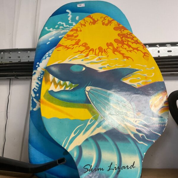Colourful skimboard with a lizard design for beach and water sports.