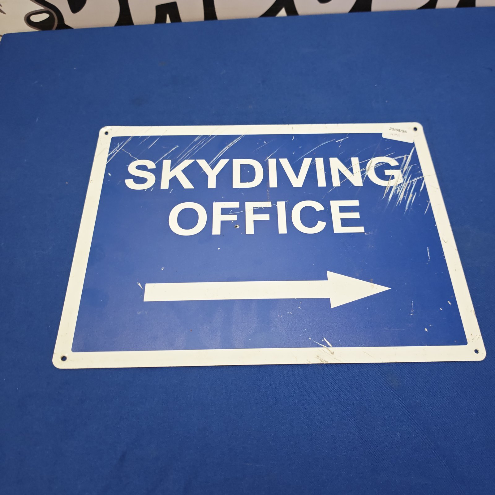 Vintage sky diving office sign with bold lettering.