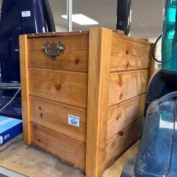 Vintage wooden storage box with metal handle, rustic style.