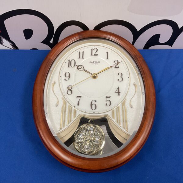 Vintage Small World Rhythm musical quartz wall clock with pendulum.