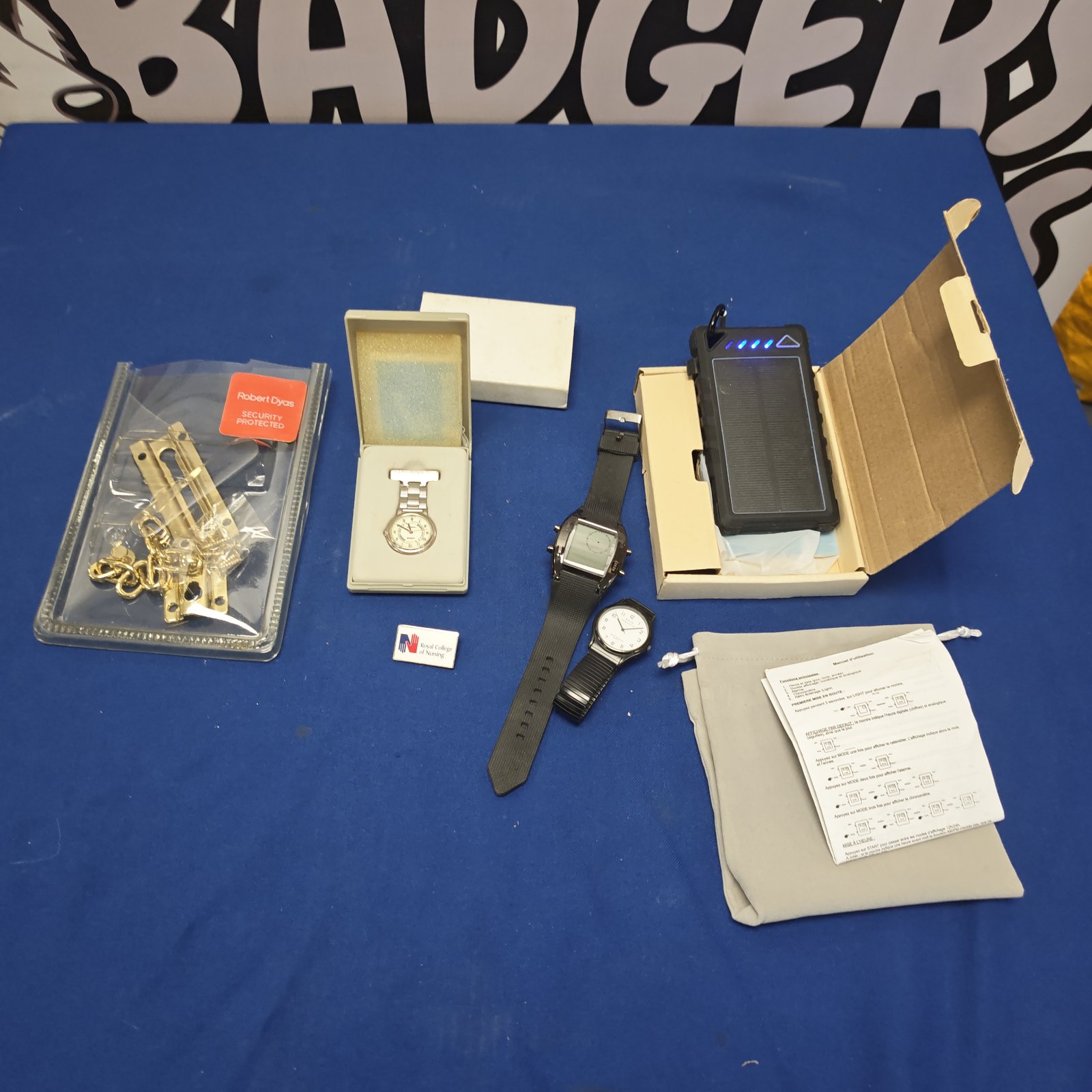 Mixed lot including solar power bank and lotus pocket watch.