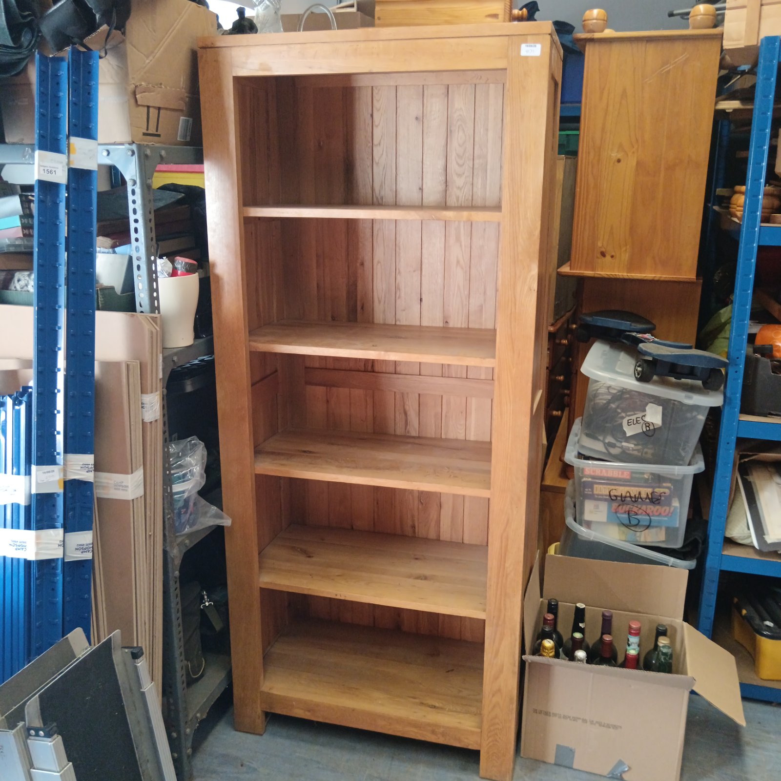 Vintage solid oak bookcase with four shelves for books and storage.