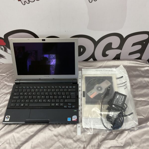Sony Vaio VGN-TZ31MK laptop with charger, vintage computing.