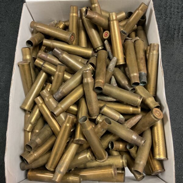 Spent brass bullet cases in a box, ideal for reloading.