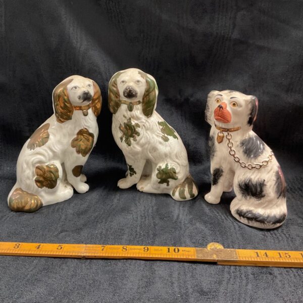 Group of three antique Staffordshire dogs, Victorian and modern.