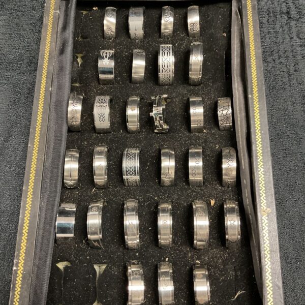 Tray of assorted stainless steel rings for crafting or collecting.