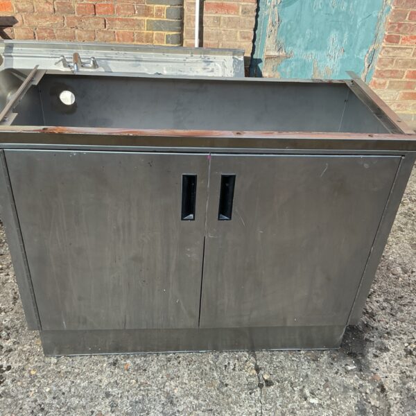 Stainless steel sink base with double doors and black handles.