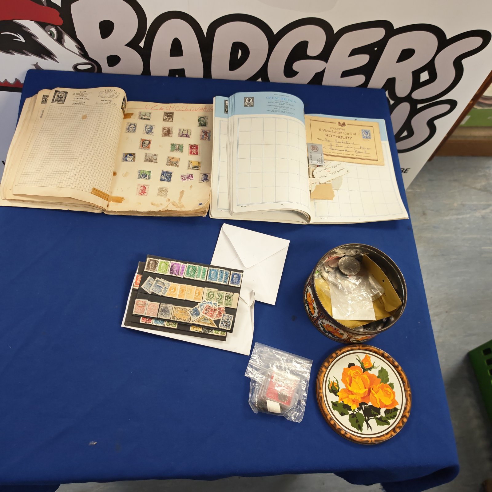 Vintage stamp albums and a tin of collectible stamps for philately.