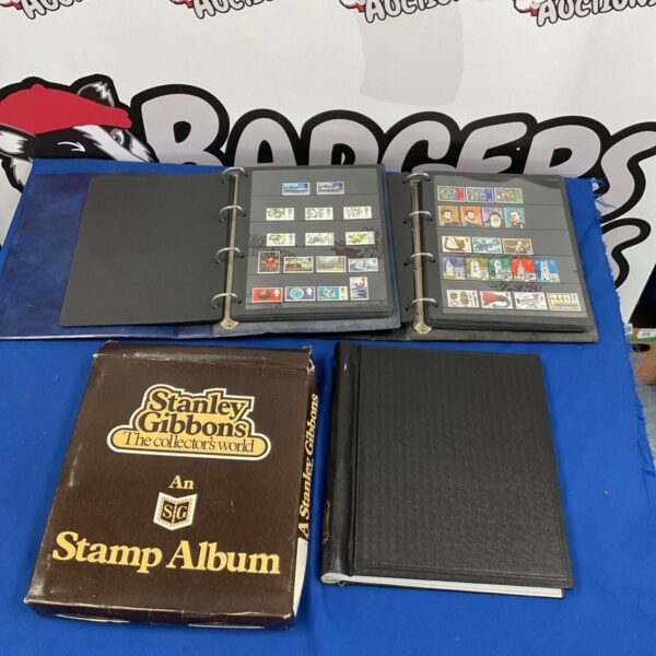 Stanley Gibbons stamp album and binder with stamp pages.