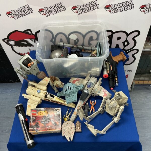 Assorted Star Wars figures and toys in a box.