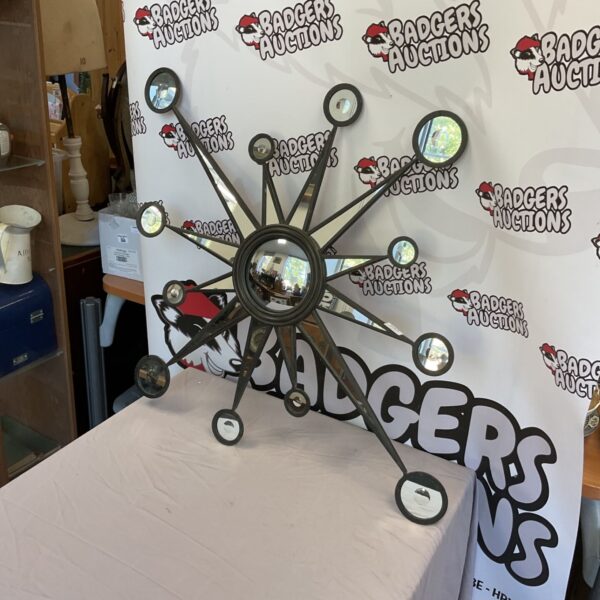 Large 36 inch starburst wall mirror with radiating mirrored segments.
