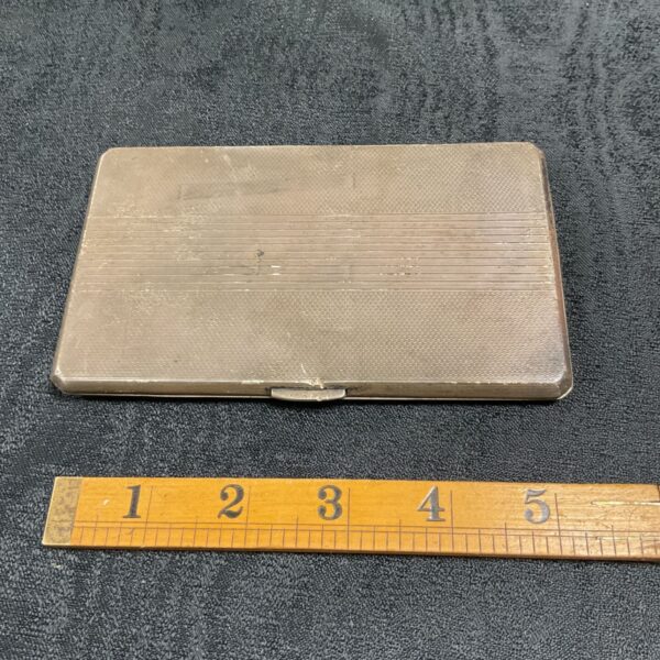 Vintage sterling silver cigarette case with ribbed texture.