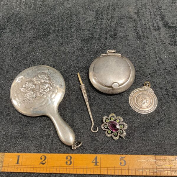 Sterling silver collectibles lot including mirror, medal, brooch and button hook.