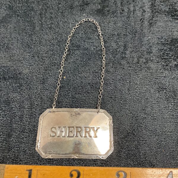Antique sterling silver sherry bottle label with chain.