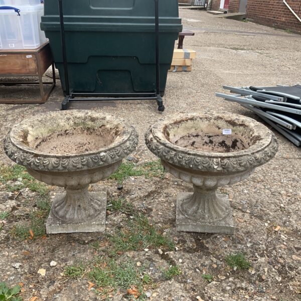Pair of weathered stone garden planters for outdoor display.