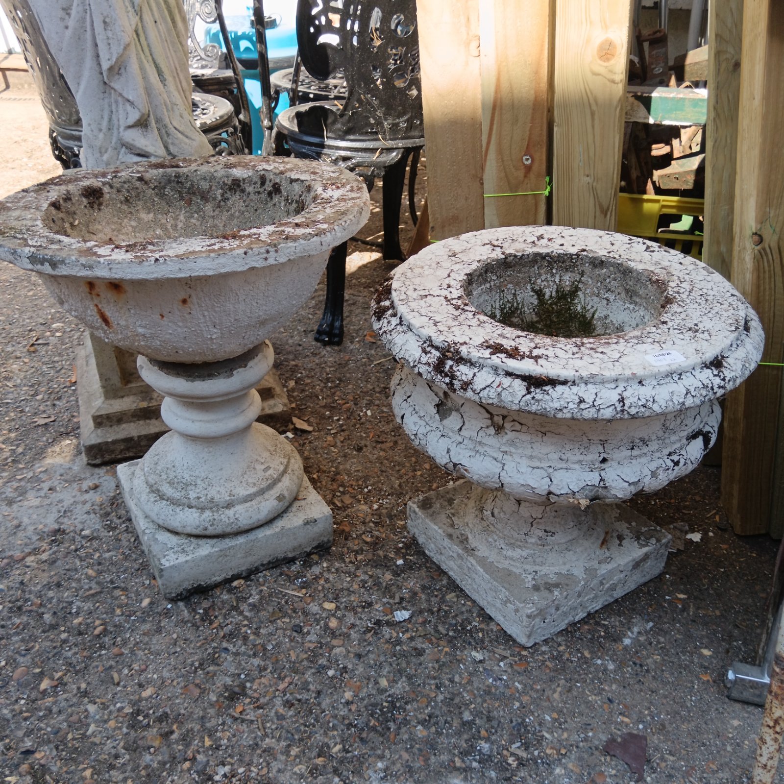 Weathered stone garden urn planters, a classic outdoor garden feature.